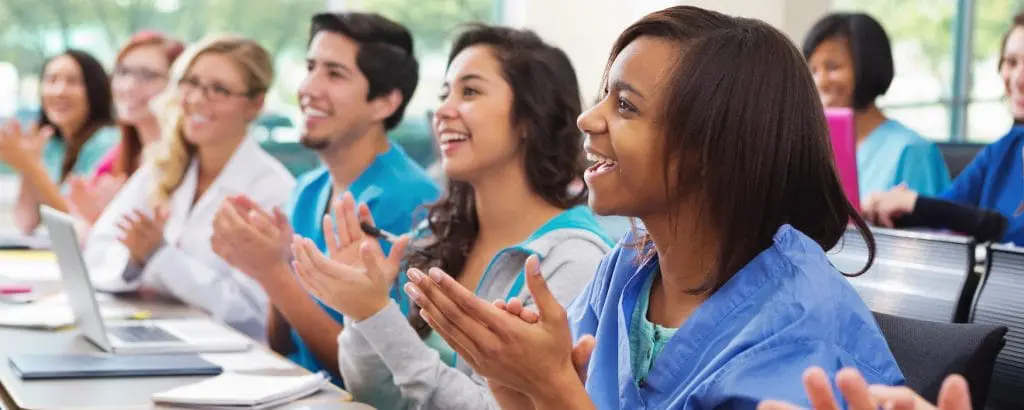 A group of med students clapping