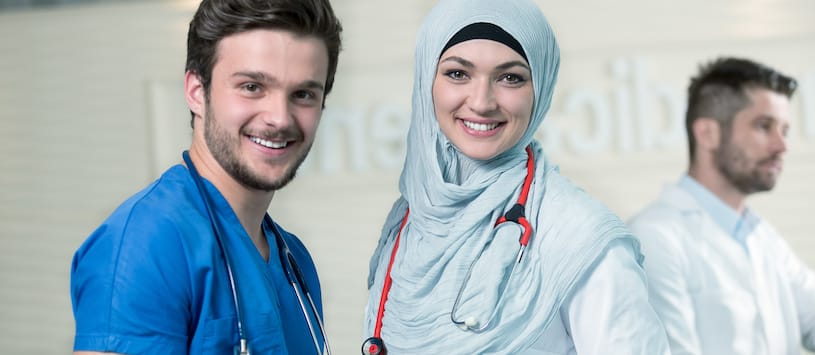 A male medical assistant with a female doctor wearing a hijab. For a thorough Medical Assisting Program come to NWSC.