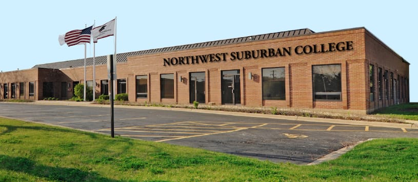 A brick building with American flags waving out front. For an allied healthcare school in Chicagoland call NWSC.